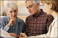 older couple discussing an estate with their attorney
