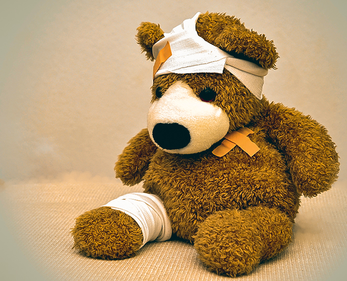 a teddy bear with various bandages