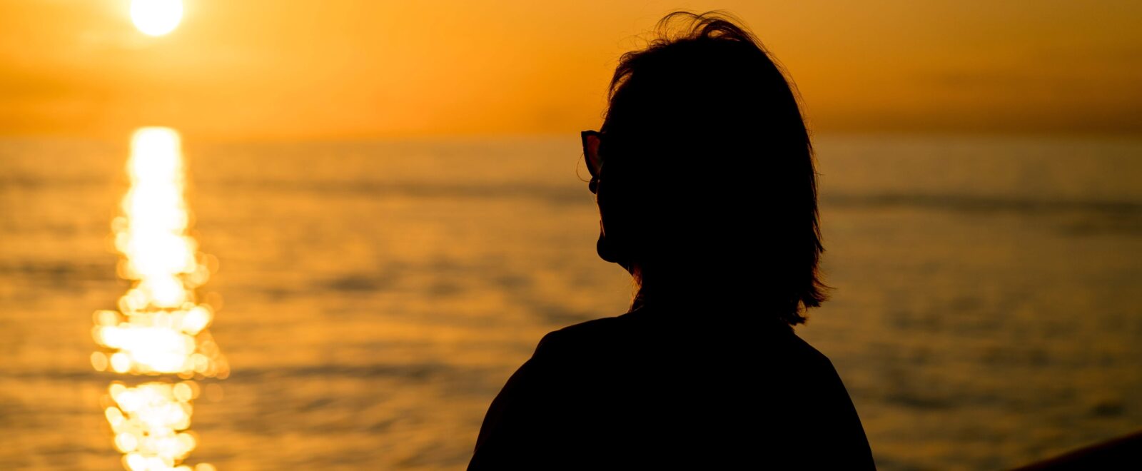 retired woman sitting on beach